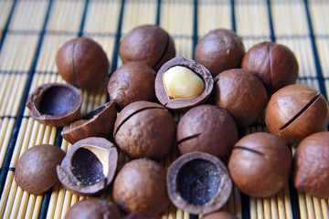 Macadamia nuts close-up. Tasty and healthy snack. Objects on a textural background.