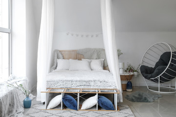 Interior of beautiful modern bedroom with spring flowers © Pixel-Shot