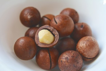 Macadamia nuts close-up. Tasty and healthy snack. Objects on a white background.