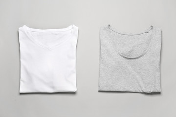 Stylish t-shirts on grey background