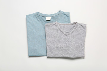 Stylish t-shirts on grey background