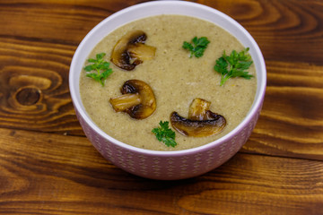 Mushroom cream soup on a wooden table