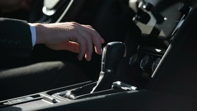 Car Driving Concept. Close-up view. Move the gear knob to the Drive position.