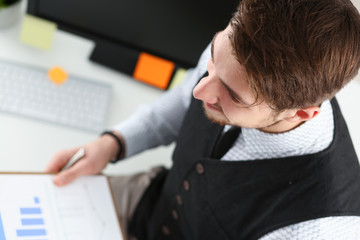 Young smile man at office workspace closeup portrait. White collar check money papers stock exchange market internal revenue service inspector earning list concept