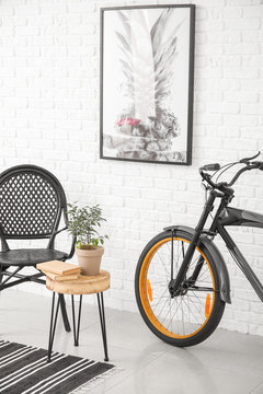 Interior of modern room with chair, table and bicycle