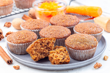 Homemade carrot cake muffins with walnuts on a gray plate, horizontal