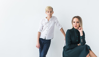 Parenting, family and single parent concept - A happy mother and teen son smiling on white background with copy space.