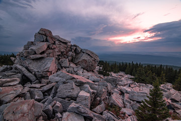 Rocks on the top of of Zyuratkul' National Park mountain at purple sunset