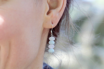 Outdoor detail of female ear wearing beautiful elegant earring