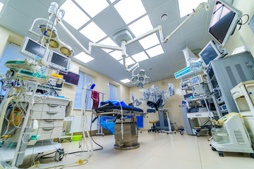 Clinic interior with operating surgery table, lamps and ultra modern devices, technology, hi-tech interior, medicine concept