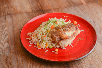 Grilled salmon steak with seasoned rice and vegetables. Restaurant food.