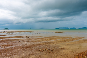 Mud sea near fishermen village at Ko Lanta island, Thailand. Cloudy weather before storm