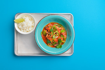 Mixed vegetable seafood salad and a bowl of rice with a piece of lime. Asian cuisine.