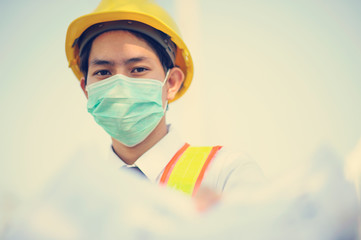 Engineer construction holding blueprint working on site