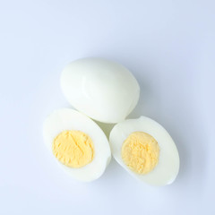 halves of boiled eggs on white background. the view from the top
