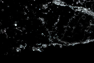 jet of water with splashes on a black background