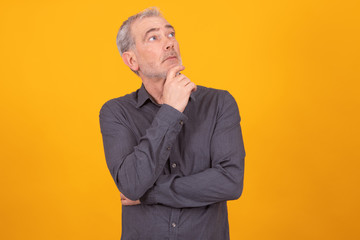 adult man isolated on color background with thoughtful expression