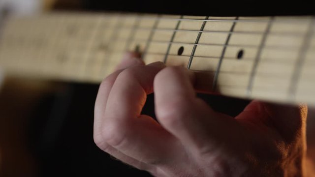 Guitar player practising scales on electric guitar.