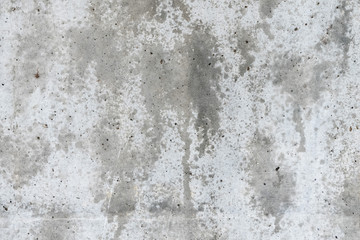 Gray concrete wall with wet spots. The background of the gray wall.