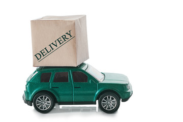 Cardboard box on the roof of the car with the text - delivery. Delivery concept.