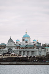Fototapeta na wymiar Russia. Kazan. August, 2019. Summer. View of the river and the city center. Russian cityscape with a church and ancient buildings. View of the Kremlin.