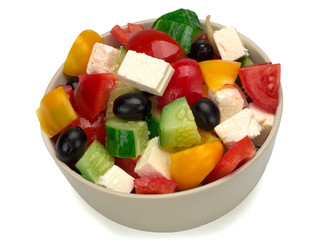 Greek salad in a plate on white background