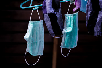 Surgical mask prepared to reuse by hanging in sunlight for drying after washing Portrait position, Covid-19