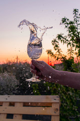 pouring water in glass at sunset