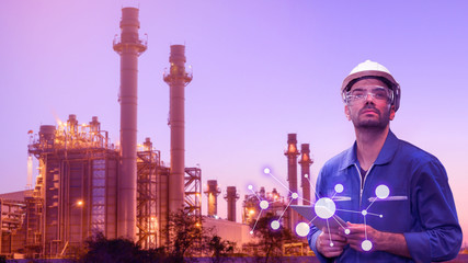 Caucasian man engineer staff worker with tablet in hand and power plant background concept.