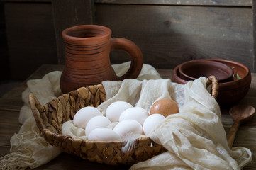 Fototapeta na wymiar Fresh white chicken eggs in a wicker basket