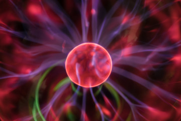 Plasma ball is a close-up. Technological background. Abstract image of chaotically moving blue lightning in a vacuum. Cosmic abstraction of the birth of a new planet.