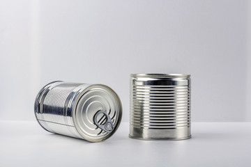 Two tin can (canned food) on white  background. Food supplies during coronavirus quarantine and self-isolation. Food delivery, donation, volunteer support. Copy space for text