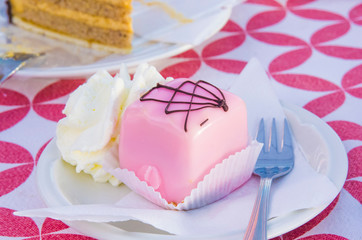 vanilla and chocolate cupcakes covered with strawberry icing and whipped cream