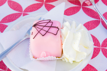 vanilla and chocolate cupcakes covered with strawberry icing and whipped cream
