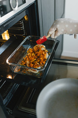 Beautiful young woman preparing dinner in the kitchen. The concept of a healthy diet and lifestyle.