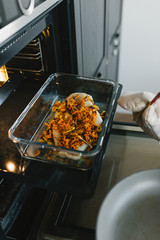 Beautiful young woman preparing dinner in the kitchen. The concept of a healthy diet and lifestyle.