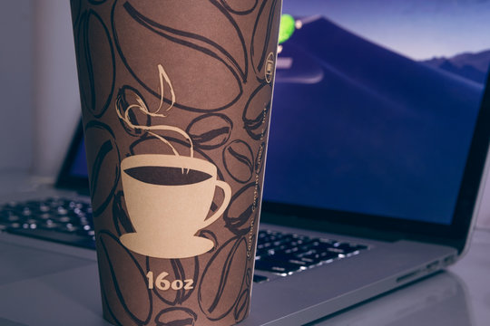 Laptop Computer and a Coffee Cup on desk