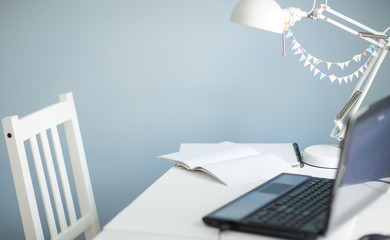 student's workplace at home. white furniture, blue walls