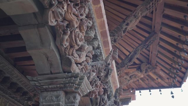 Intricate Wood Carvings Of The Roof Beams And Columns Of A Temple In Patan Durbar Square, Nepal - Low-Angle Shot