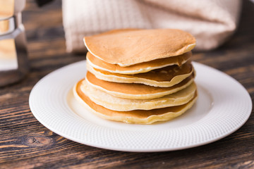 Homemade delicious pancakes on white plate. Breakfast concept