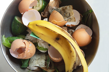 reduce, reuse, recycle - collection food scraps from the kitchen in a bowl to put into a compost bin