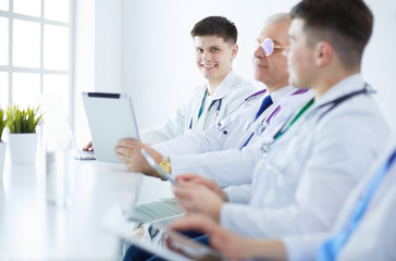 Medical team sitting and discussing at table