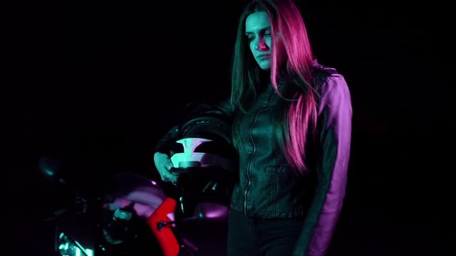 Sexy Girl on a sports bike in a neon light.Night racer.Neon concept