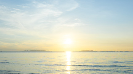 Beautiful beach sunrise with blue sea and golden light sky  cloud background