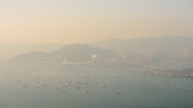Lots Of Container Cargo Freight Ship Sailing At Victoria Harbour With Stonecutters Highway Bridge On A Foggy Morning In Hong Kong.- high angle shot