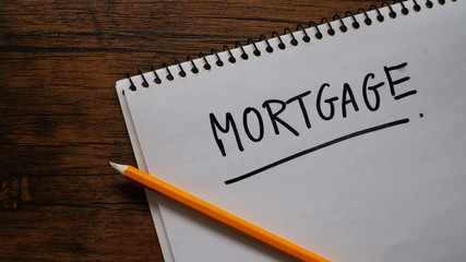 Mortgage word on wood background - financial & business concept.