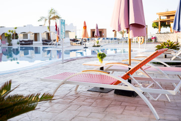 Chaise-longues near the hotel pool. Egypt tour. The morning of a summer day. Luxury vacation....