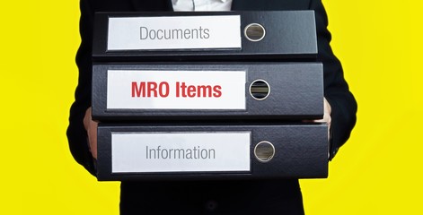 MRO Items – finance/economics. Man carries a stack of 3 file folders. A folder has the label MRO Items. Business, statistics concept - obrazy, fototapety, plakaty