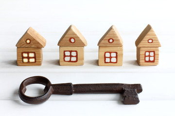 very big key on the background of wooden houses. free spaces for individual accommodation