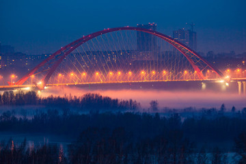 Fototapeta na wymiar Illumination of Bugrinskiy bridge in winter, Novosibirsk, Siberia